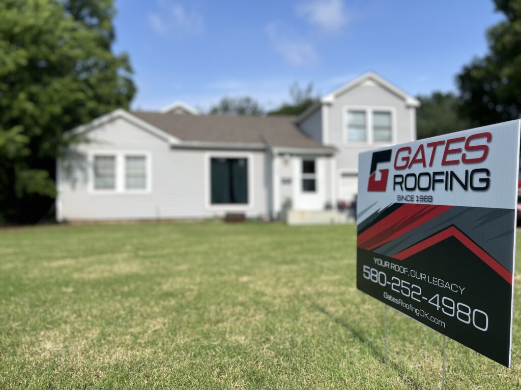 Gates Roofing yard sign in front of a house, showcasing roofing services since 1969